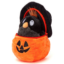 Halloween crow stuffed animal peeking from a jack-o'-lantern plush basket, angled view