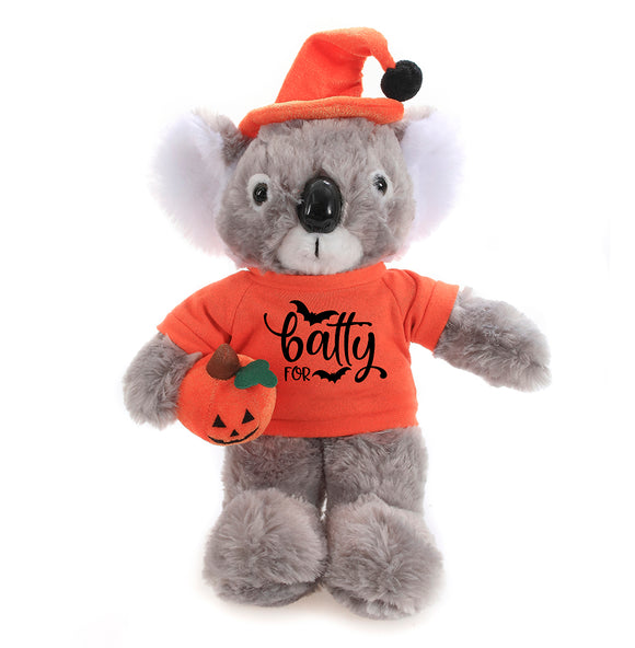 Halloween Koala Plush 12" in a front-facing pose wearing a Halloween t-shirt and hat while holding a pumpkin treat bag